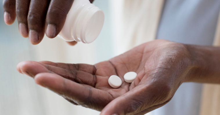 A woman pouring pills into her hands.