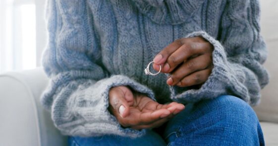 Woman removing ring from finger