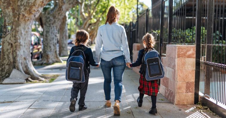 Woman walking with two children