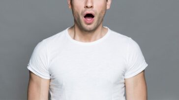 Astonished man in white T-shirt