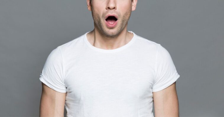 Astonished man in white T-shirt