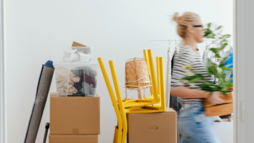 Woman carrying moving boxes
