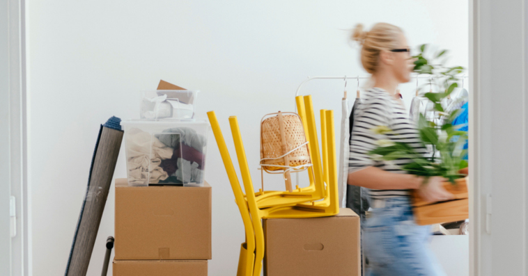 Woman carrying moving boxes