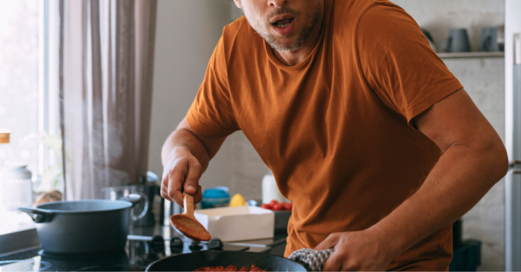 Man looking shocked while cooking