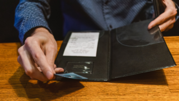 A man paying a bill at a restaurant.