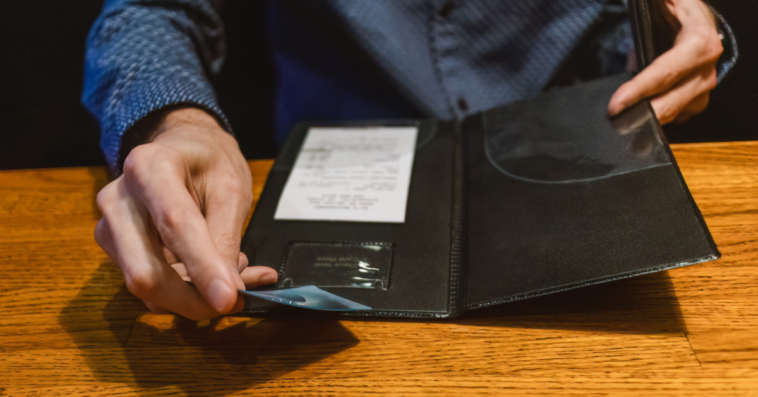 A man paying a bill at a restaurant.