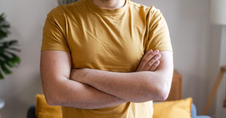 Guy in a yellow t-shirt crossing arms