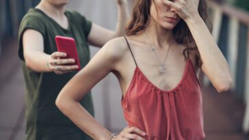 Two women arguing over something on smartphone