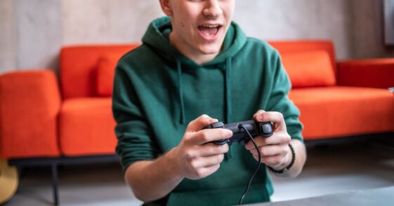 Teenager playing video game