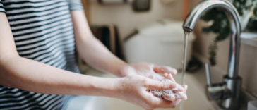 A woman washing her hands.