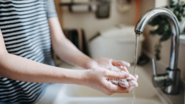 A woman washing her hands.