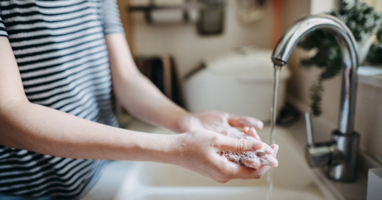 A woman washing her hands.