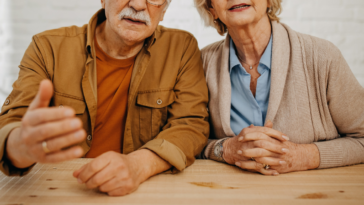 older couple speaking harshly to person out of frame