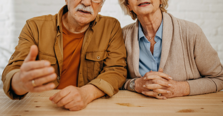 older couple speaking harshly to person out of frame
