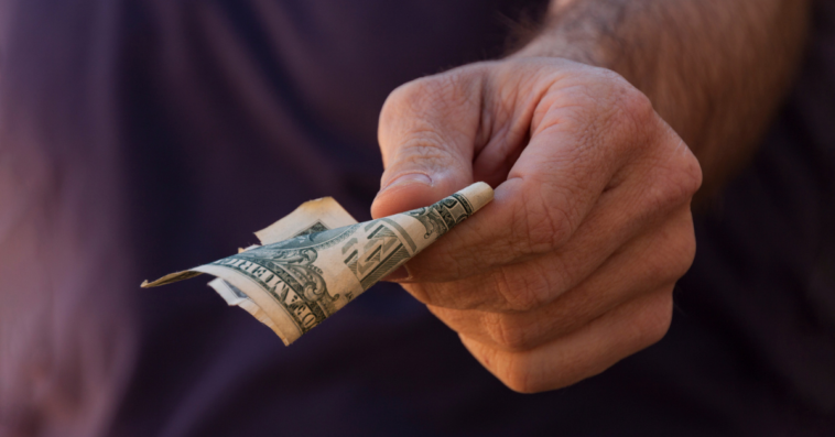 hand holding United States 1 dollar bill