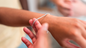 Bracelet being placed on someone's wrist