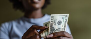 Close up of a woman counting money.