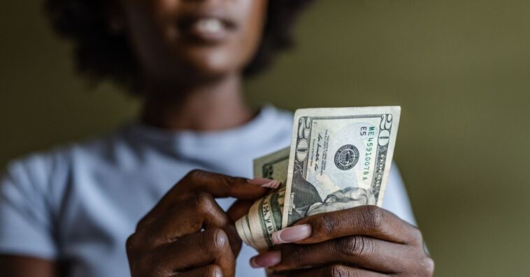 Close up of a woman counting money.