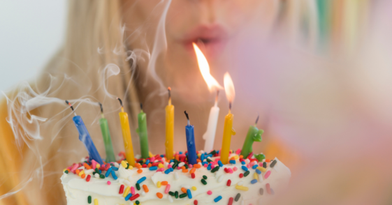 Woman blowing out birthday candles