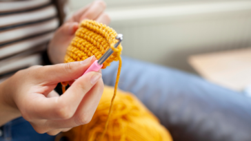 A woman crocheting.