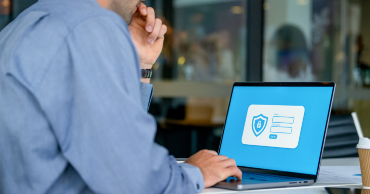 Guy entering password on computer to work