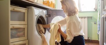 Woman putting cashmere sweaters in the washing machine