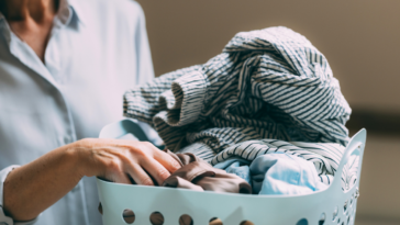 older woman with full laundry basket