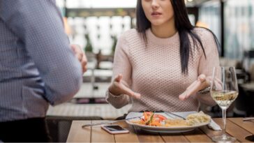 Unhappy restaurant patron complaining about her meal to server