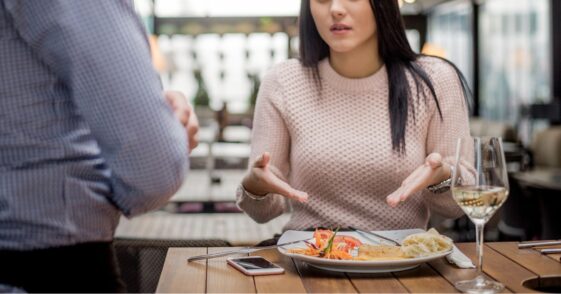 Unhappy restaurant patron complaining about her meal to server