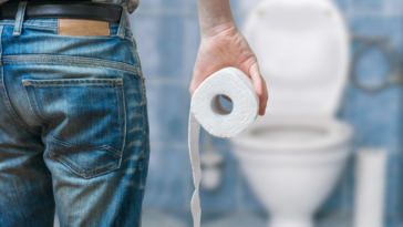 Man holding toilet paper