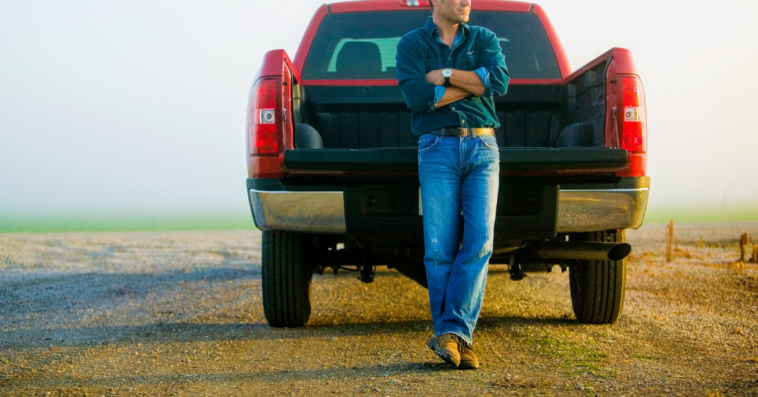 man leans against tailgate of truck