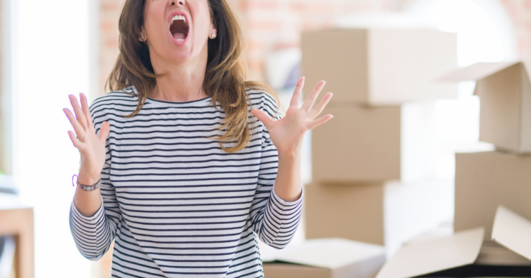 Angry woman with moving boxes