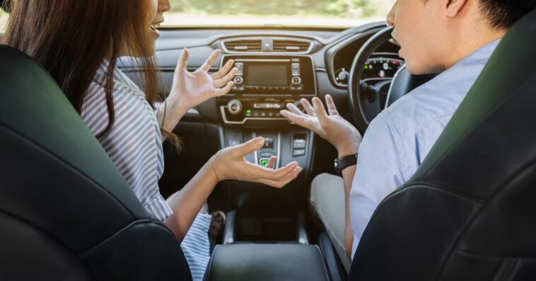 Couple arguing while driving a car.