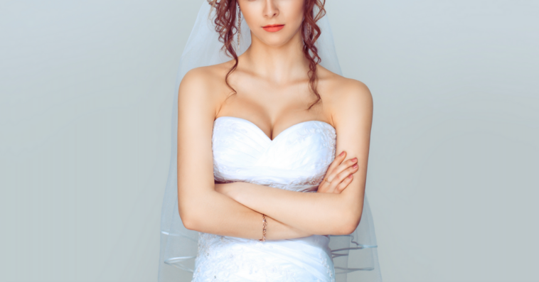 A bride with her arms crossed.