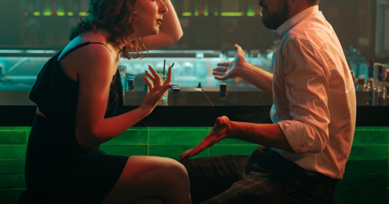 Couple arguing at a bar