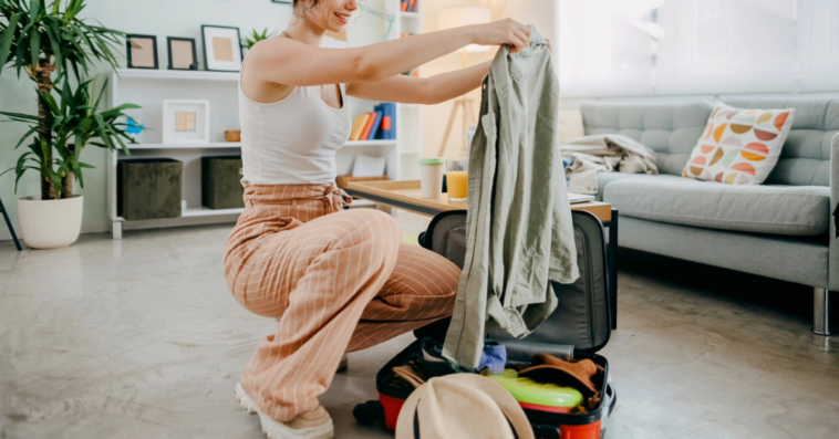 woman packing suitcase for vacation