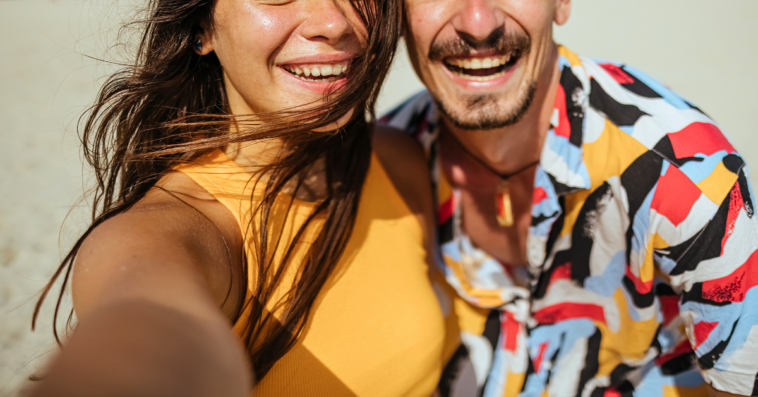 couple taking selfie on beach