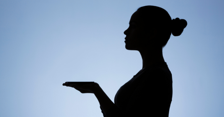 silhouette of server with payment tray on hand