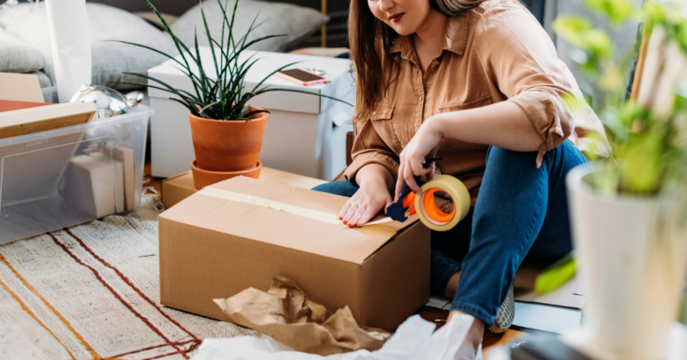 young woman packing moving boxes