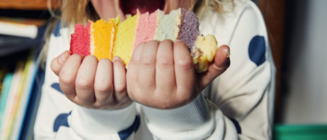 A young boy eating a large piece of cake.