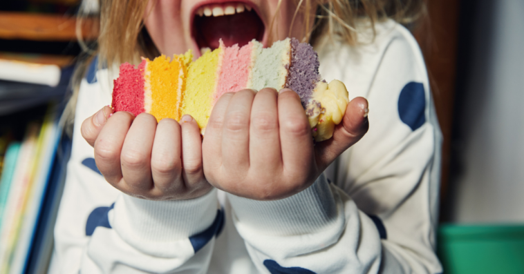 A young boy eating a large piece of cake.