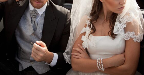 Newlywed couple arguing in car.