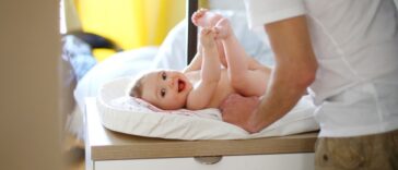 A dad with his baby on the changing table