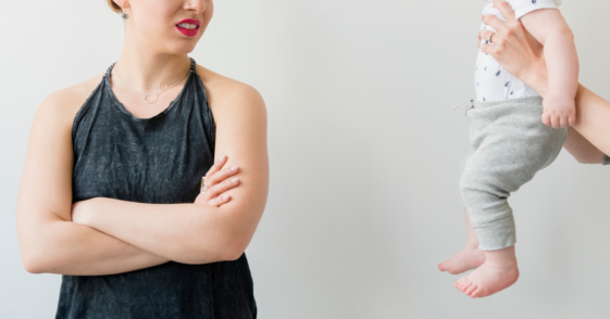 Woman turning away from holding someone's baby