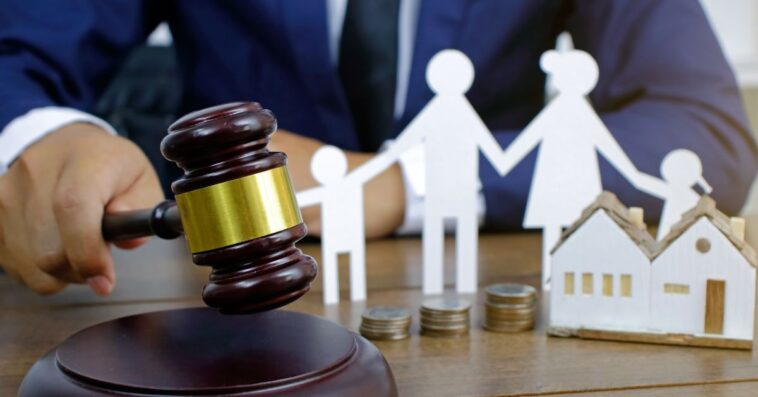 Family law concept. Cropped shot a man in a suit bringing a gavel down.