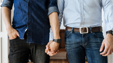 Two men holding hands.