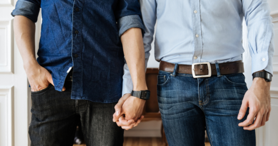 Two men holding hands.