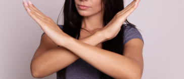 Woman crossing her arms in a 'no' motion