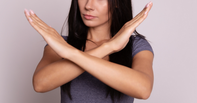 Woman crossing her arms in a 'no' motion