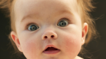 A baby with a shocked expression on his face.